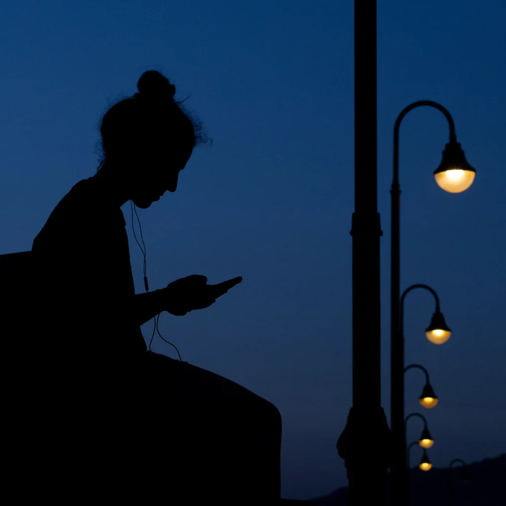 Silhueta de uma pessoa observando a cidade à noite, representando reflexão sobre desejo, sucesso e vazio na psicanálise