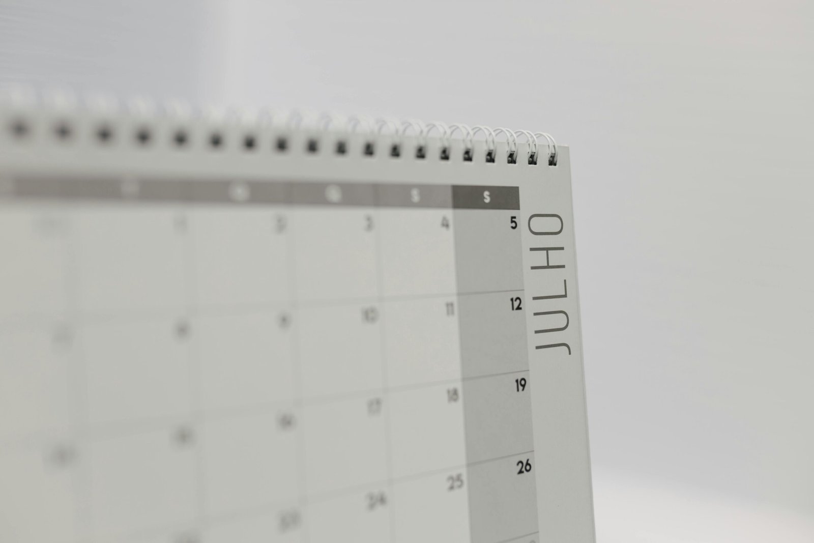Close-up of a minimalist calendar showing the month of July.